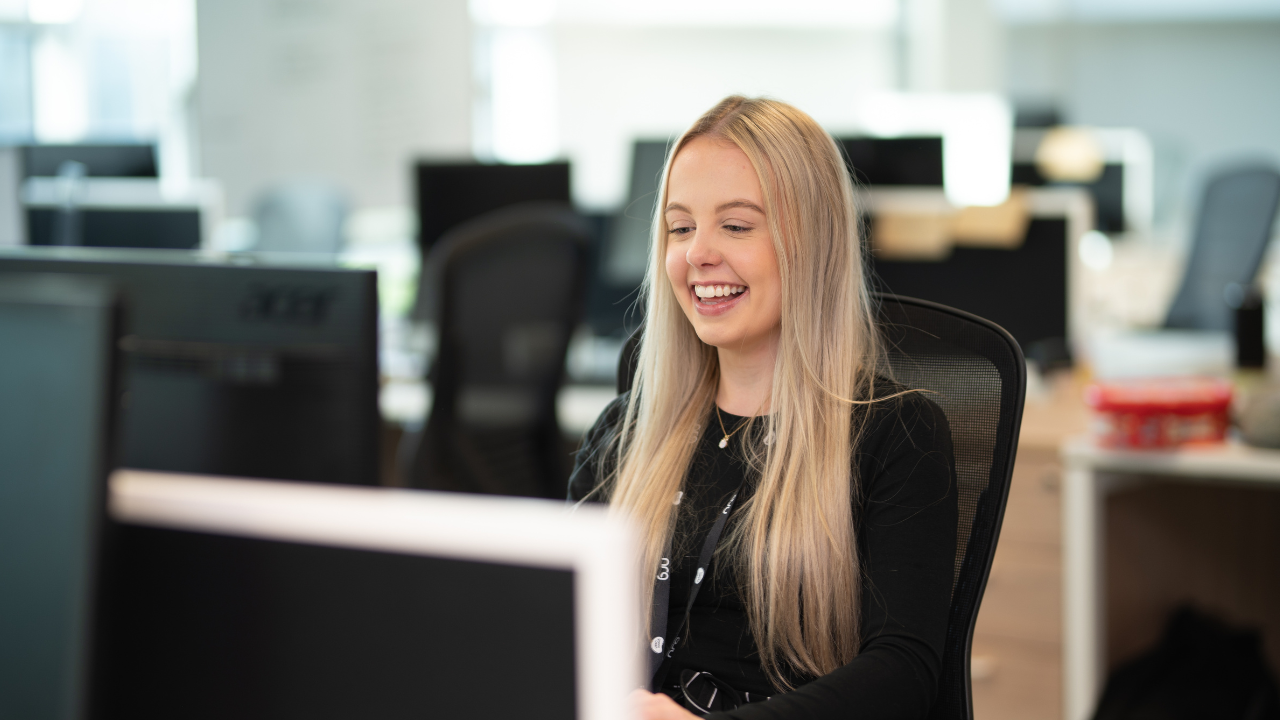 Woman smiling working on a computer